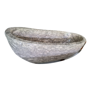 White and grey veined marble bathtub with polished interior, complete side view