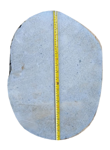 Sawn-cut river stone stepping stone on a white background with measuring tape