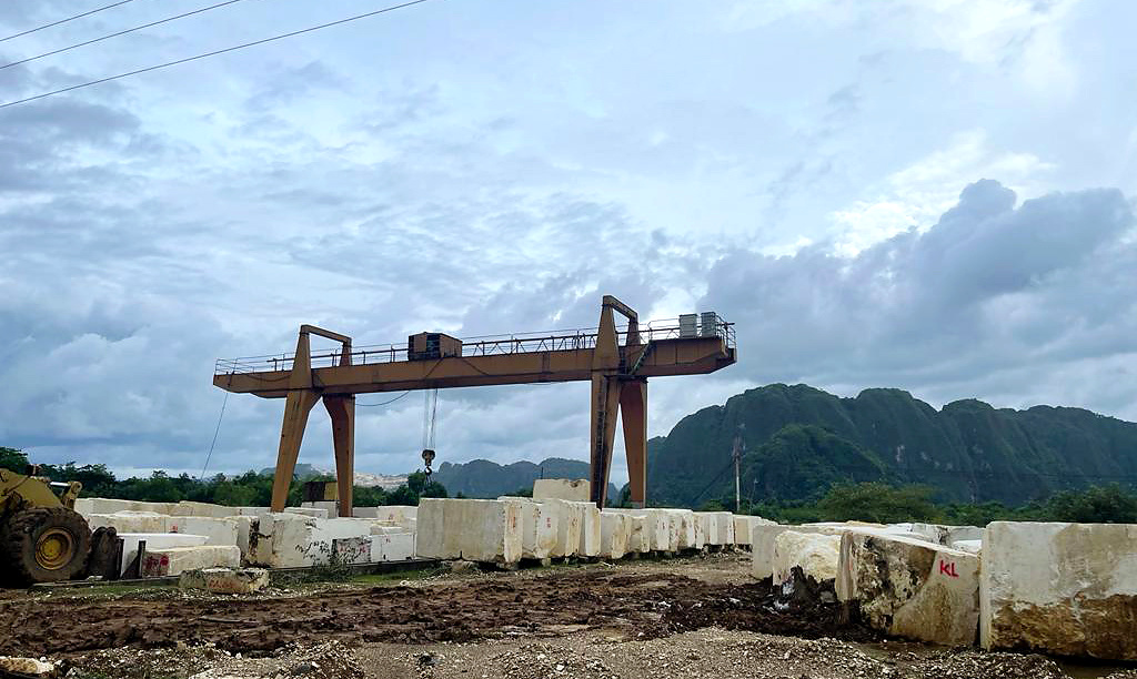 Marble blocks beside a gantry crane at the quarry